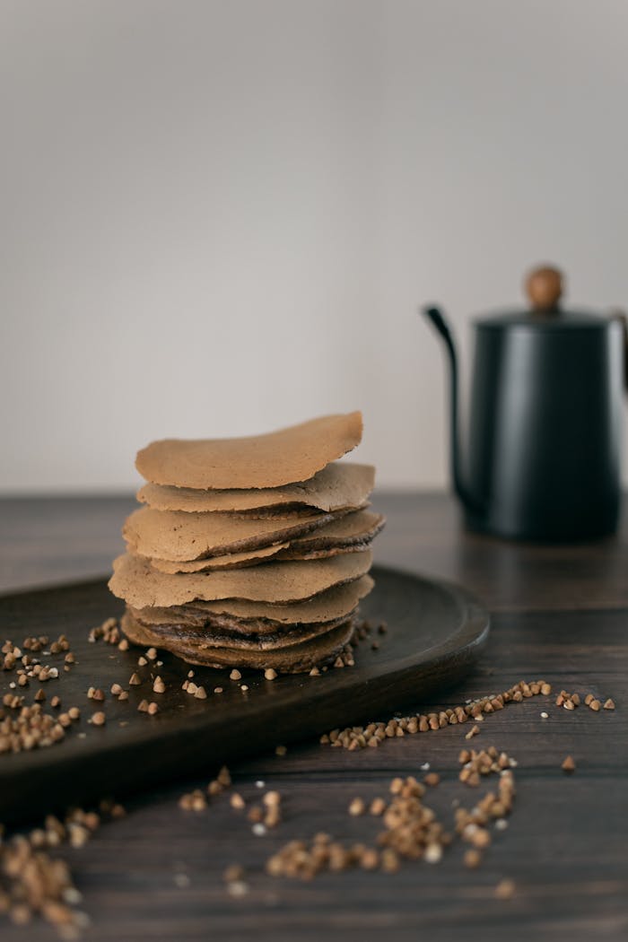 Delicious homemade buckwheat pancakes on a wooden board indoors.
